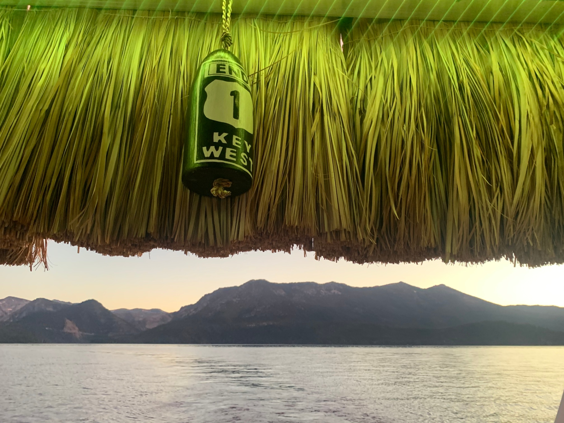 Key West mile zero buoy hanging from the thatched tiki roof over Lake Tahoe