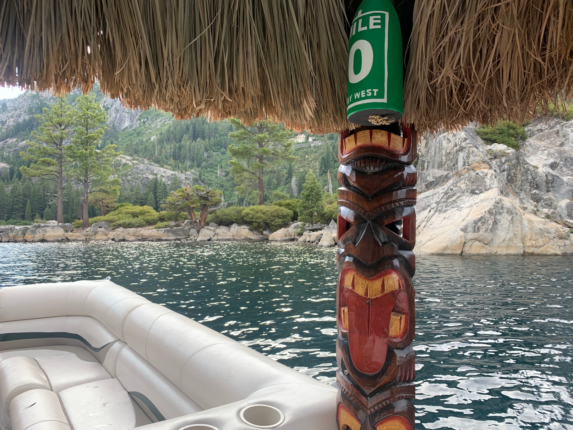 Tiki totem with Emerald Bay granite cliffs and pines