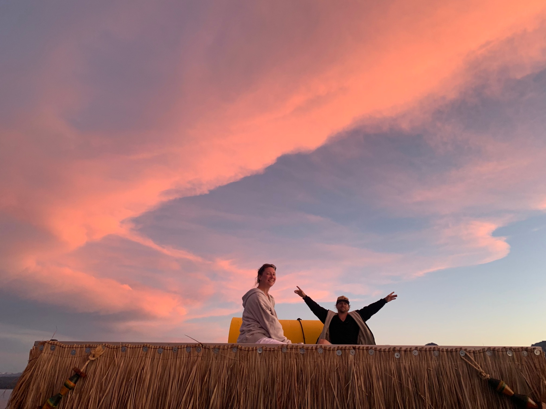 Friends on the upper deck under a pink Tahoe sunset