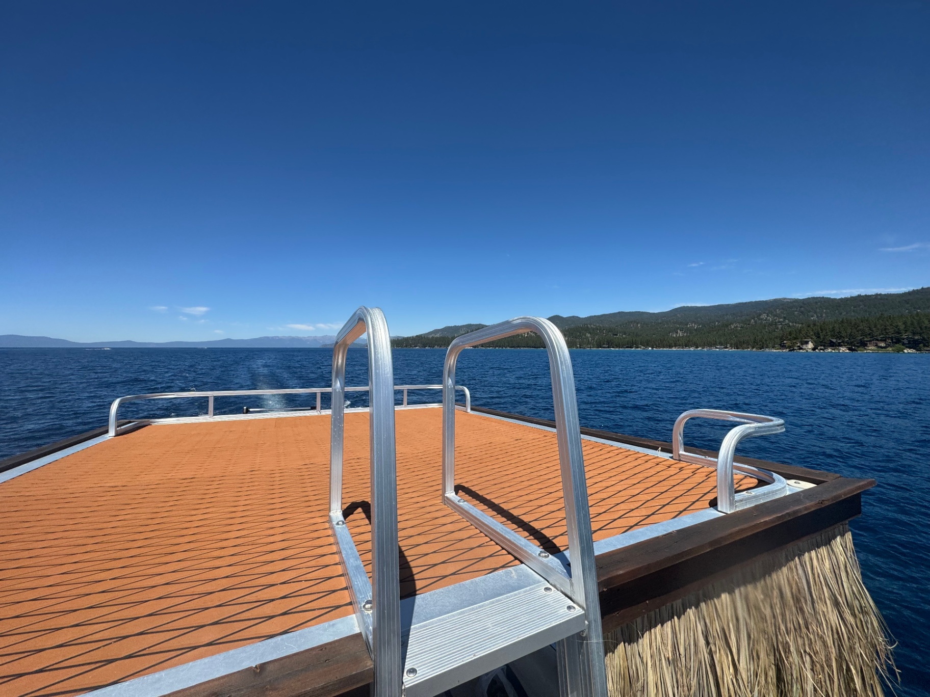 Upper sundeck of the tiki boat with orange decking